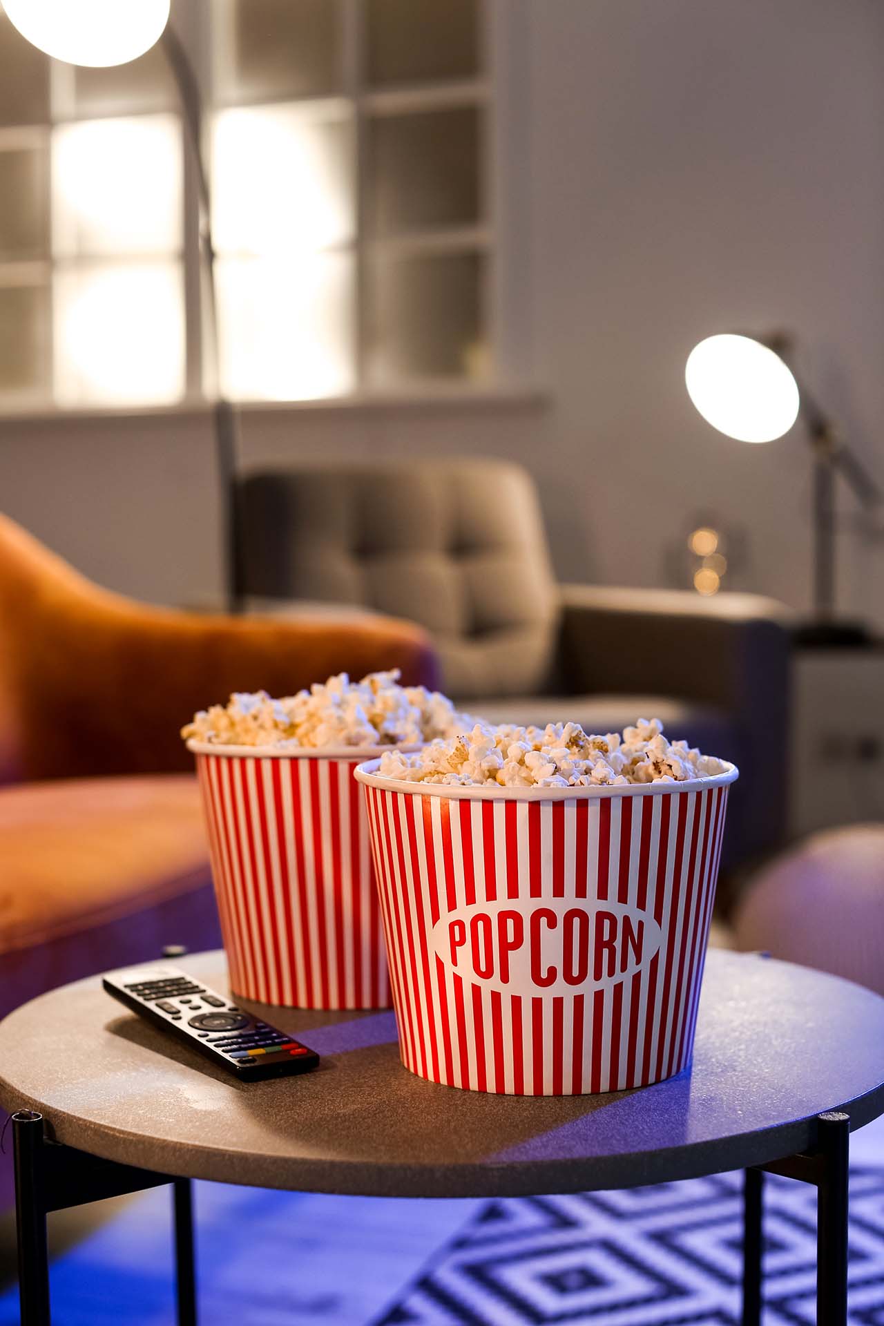 Buckets,With,Tasty,Popcorn,And,Tv,Remote,Control,On,Table