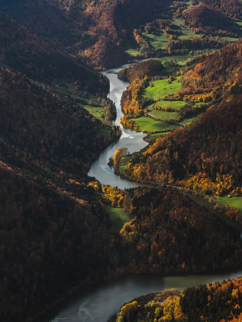 A river flows through a hilly landscape.
